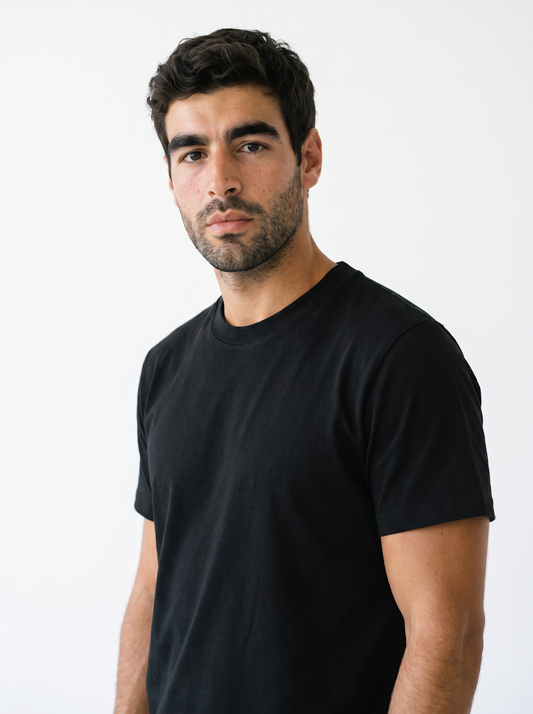 BLANC Unisex Basic Tee Black worn by model on white studio background